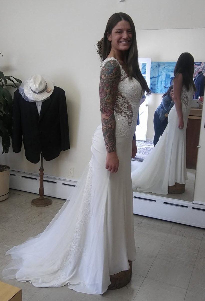 Bride in a fitted lace gown with a long train