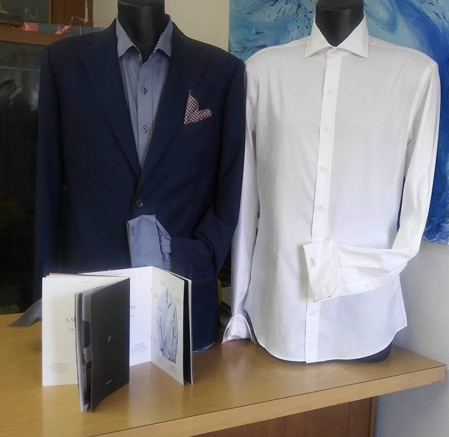 Custom navy blazer and white dress shirt on forms
