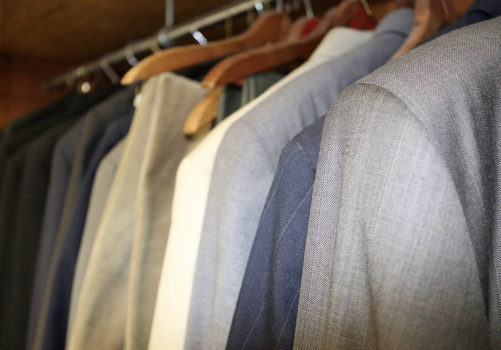 Fine wool suits on wooden hangers
